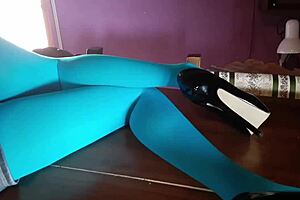 Beautiful Milf In Pantyhose And Heels Lies On The Table. Teasing With Her Sexy Legs.