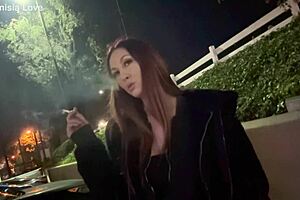 Artemisia Love smoking outdoors.