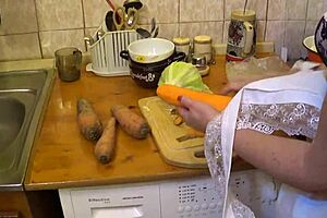 The mature amateur carefully prepares the carrots for cooking.