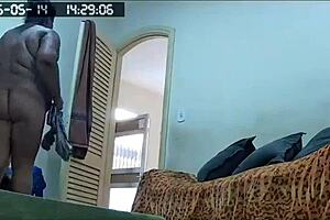 Hidden camera catches the maid cleaning naked at home.