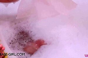 Enchanting brunette muse relaxes in a sensual bath on the sofa