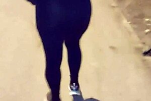 Look at this mature street whore flashing her thong in transparent leggings outdoors.