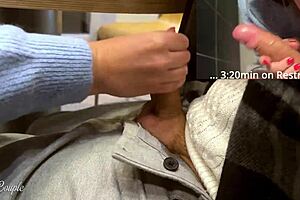 Cute Babe Gives Blowjob in Public Toilet After Handjob Under Table