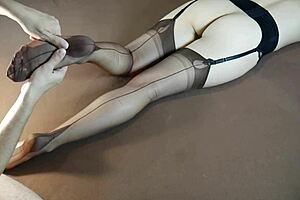 Horny MILF in stockings gets soles massaged until moaning with tickling fetish play. Feet worship builds to intense nylon-covered orgasm.