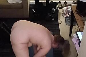 The hot milf with big natural tits performs naked yoga routines. She stretches gracefully in various poses.