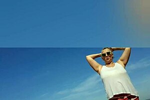 Far out! This sexy African milf flashes big natural tits and pussy lips on the beach.