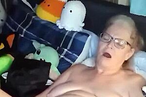 Curvy mature woman performs naked yoga in her room. She spreads legs wide and fingers her saggy tits until orgasm hits.