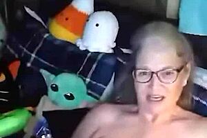 Curvy mature woman performs naked yoga in her room. She spreads legs wide and fingers her saggy tits until orgasm hits.