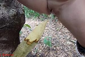 hey check it, this perverted slut is squirting piss from a wooden stake deep in the forest outdoors 😈🌳💦