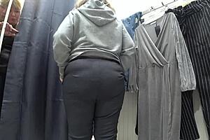a plump milf with juicy ass in white panties and big tits in bra caught on hidden camera in public dressing room
