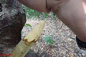 hey check it, this perverted slut is squirting piss from a wooden stake deep in the forest outdoors 😈🌳💦