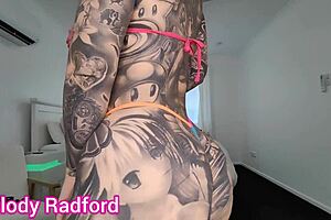 She tries on a sheer micro bikini in a casual haul, showing off her big tits and ass in the bedroom.