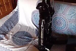 Petite brunette milf in sexy total black outfit with fishnets pantyhose and over-the-knee boots