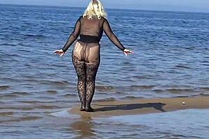 black style milf flashes big tits on the beach