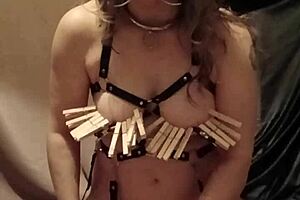 French milf slave in leather harness and mouth spreader performs solo outdoor bondage session with dildo and spanking for humiliation.