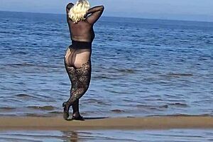 black style milf flashes big tits on the beach