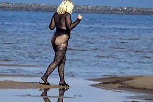 black style milf flashes big tits on the beach