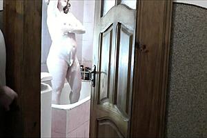 naked sexy blonde woman in bathroom without panties. Pervert man roommate watches outside masturbating cock for cumshot on old young 18+ wet pussy with natural tits.